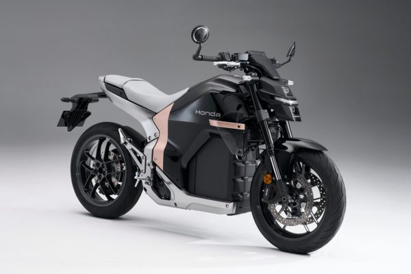 Honda WN7 electric motorcycle showcased at global launch, featuring futuristic aerodynamic design.