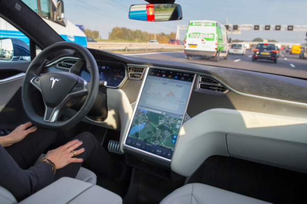 A Tesla vehicle navigating a complex, multi-lane urban intersection in Shanghai using autonomous driving software