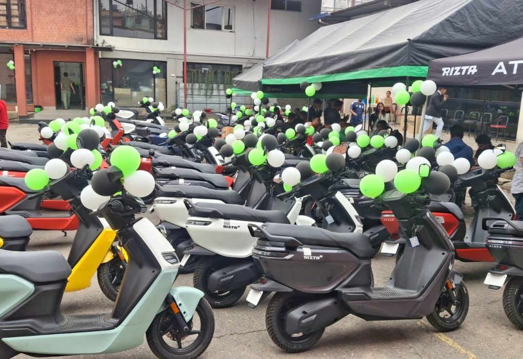 A massive lineup of colorful Ather 450X and Ather Rizta electric scooters parked outside a decorated Vaidya Energy delivery venue in Kathmandu.