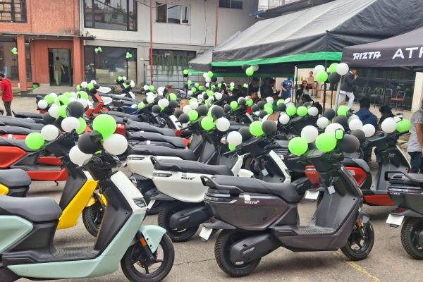 A massive lineup of colorful Ather 450X and Ather Rizta electric scooters parked outside a decorated Vaidya Energy delivery venue in Kathmandu.