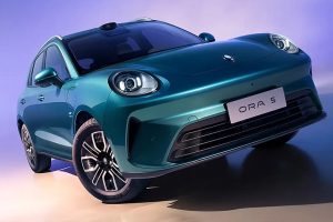 The side profile of the sleek, retro-futuristic GWM Ora 5 electric sedan showcasing its sweeping coupe roofline.