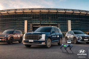 A lineup of custom-branded Hyundai IONIQ 5 and IONIQ 6 electric vehicles charging at a solar-powered depot outside a World Cup stadium.
