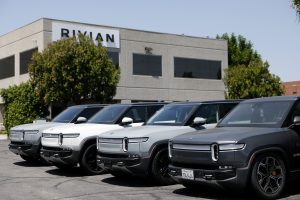 The sleek front fascia of the newly launched Rivian R2 electric SUV parked under studio spotlights