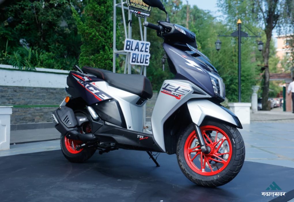The sporty front fascia of the TVS Ntorq 125 Race XP Blaze Blue scooter featuring sharp LED headlamps and signature red alloy wheels.
