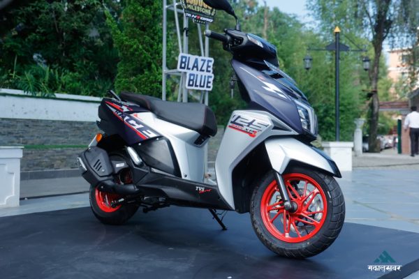 The sporty front fascia of the TVS Ntorq 125 Race XP Blaze Blue scooter featuring sharp LED headlamps and signature red alloy wheels.