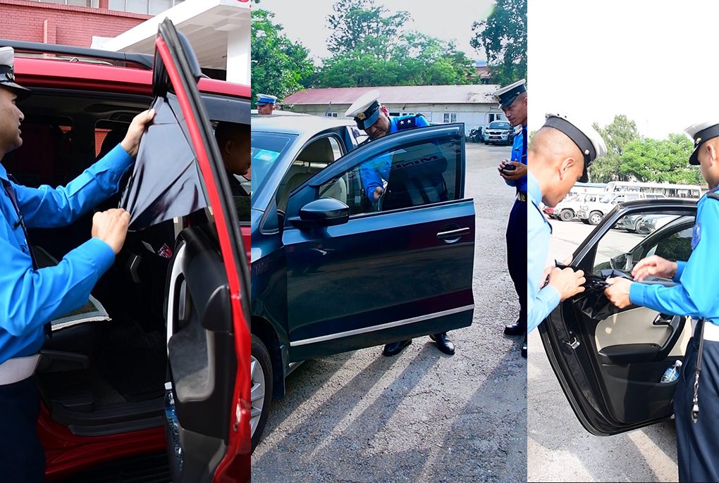 Traffic police removing illegal black tints from the official government vehicle of the Home Minister.