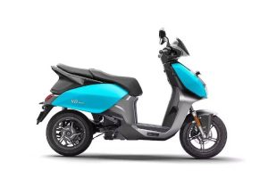 A sleek modern Hero Vida electric scooter in a striking metallic hue, showcasing its unique split-seat setup and futuristic LED headlamp